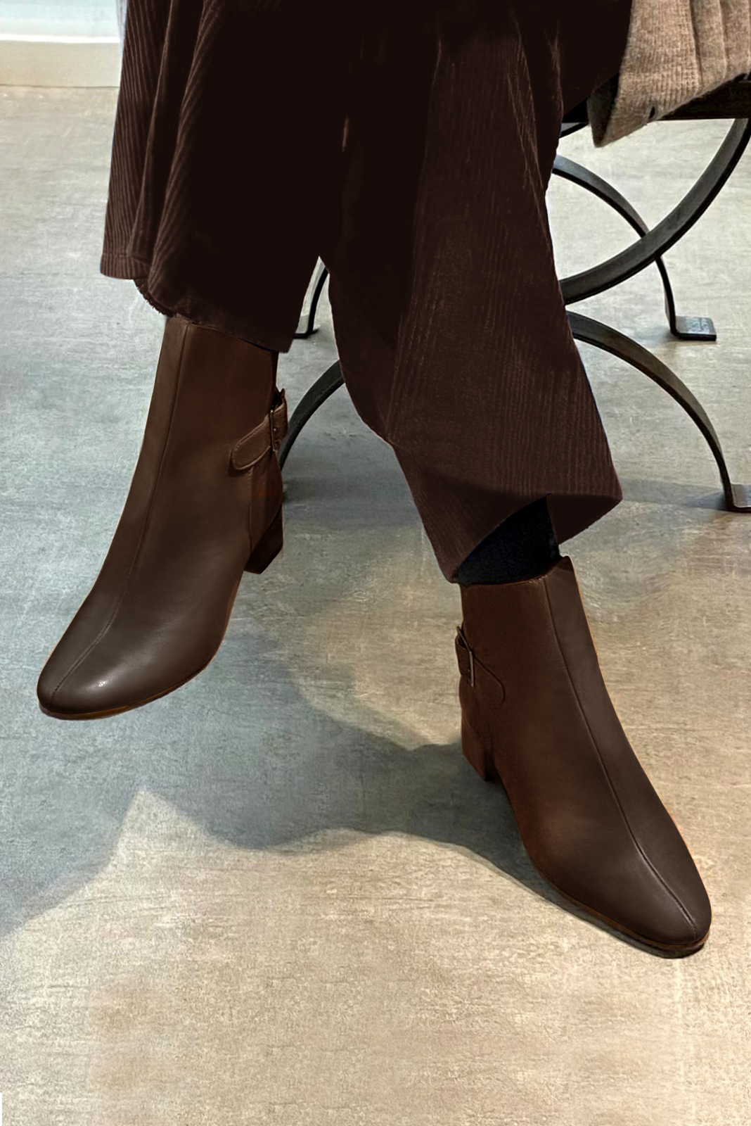 Dark brown women's ankle boots with buckles at the back. Round toe. Low block heels. Worn view - Florence KOOIJMAN